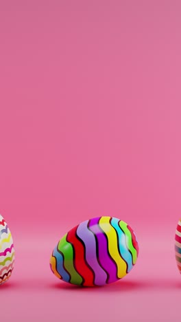 three colorful striped eggs on pink background with pink background. vertical looped animation