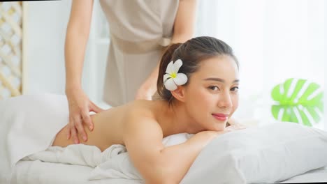 woman receiving back massage at spa