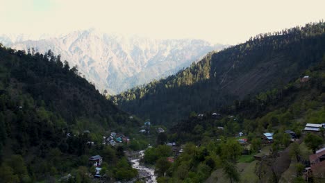kashmir valley aerial view of the village - aerial drone view of a beautiful valley with flowing streams and houses surrounded by mountains