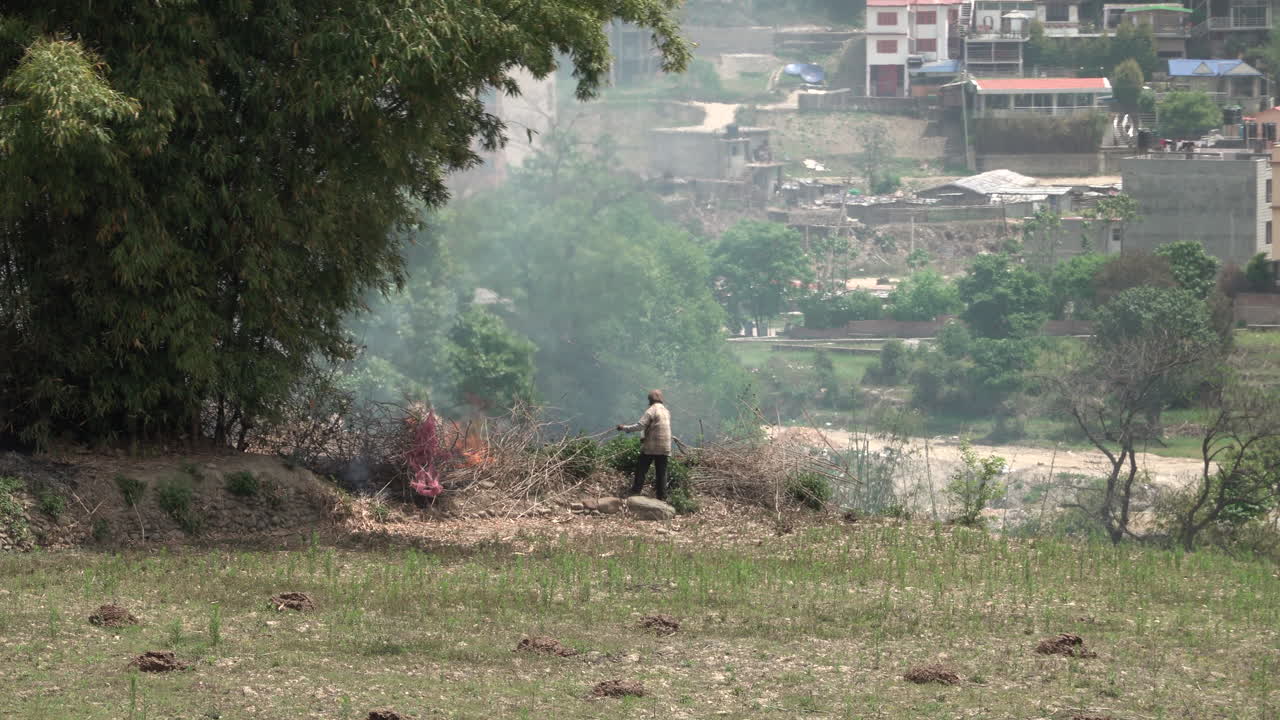 A small brush fire on a hillside.