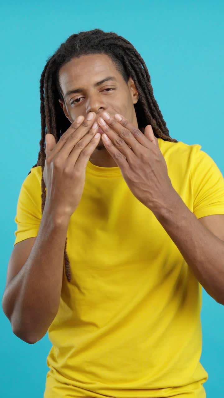 Man with Dreadlocks Smiling in Yellow T-Shirt