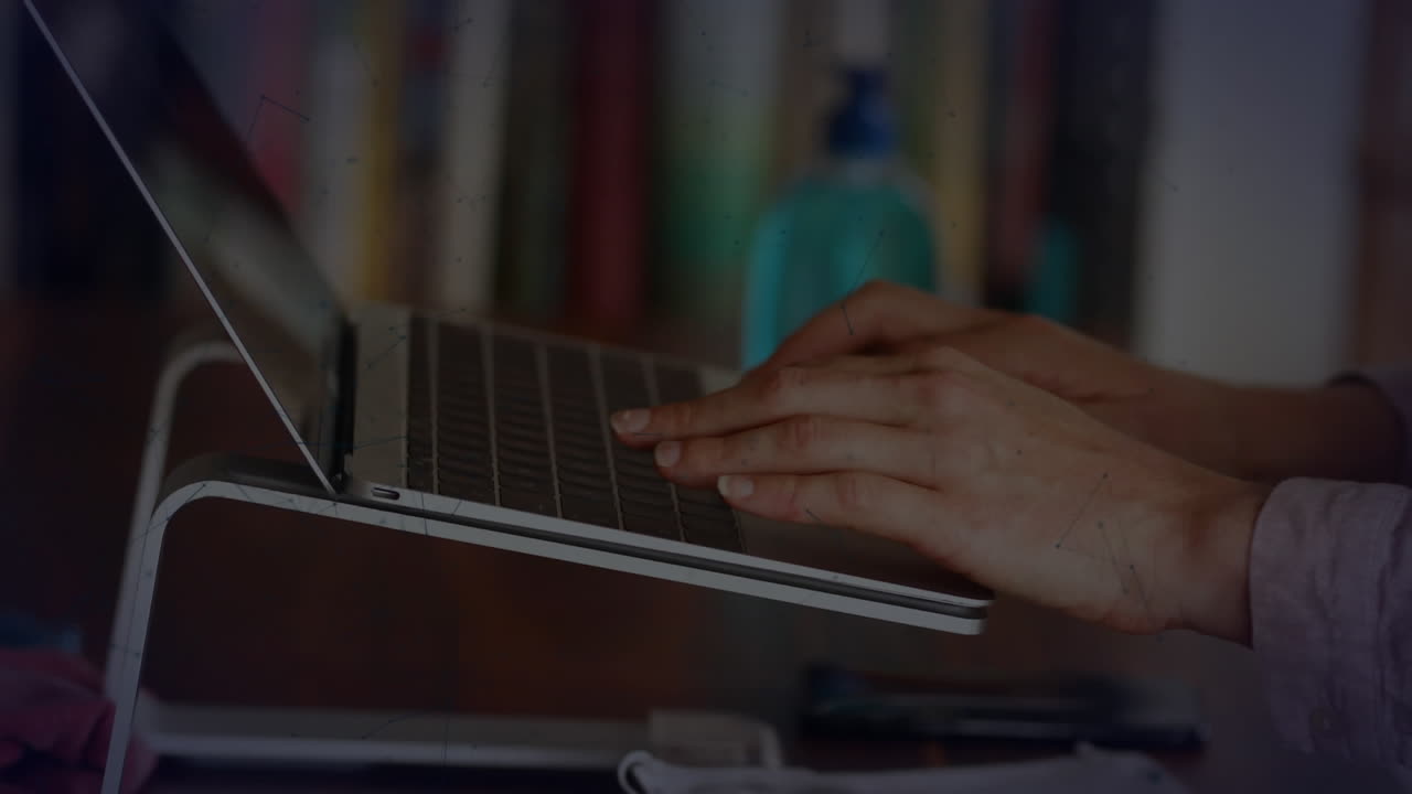 Animation of shapes over biracial businesswoman using laptop