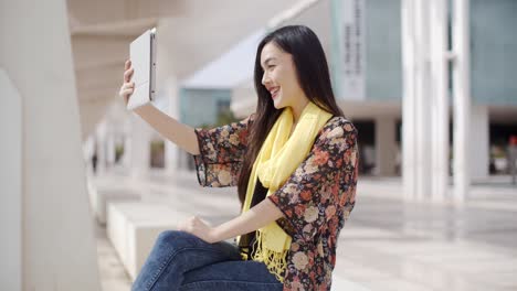 Woman-taking-a-self-portrait-with-tablet