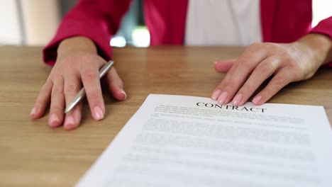 hands on a contract document with a pen