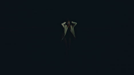 Girl stepping night shore in bikini jacket rear view. Fashion model turn camera