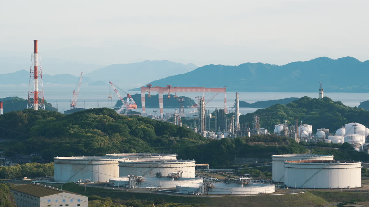 Industrial plant with smoking chimneys and burning flare stacks