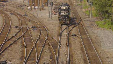 a railroad train engine creeps slowly to a level intersection in youngstown, ohio