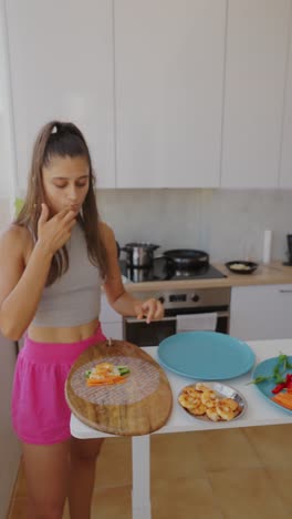 young woman making fresh spring rolls in a kitchen