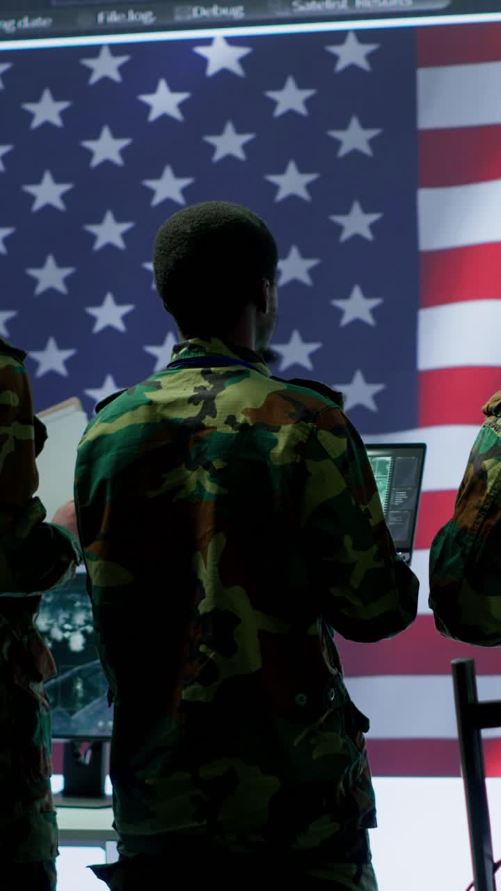 Vertical Video Military personnel work in a high tech environment safeguarding classified data
