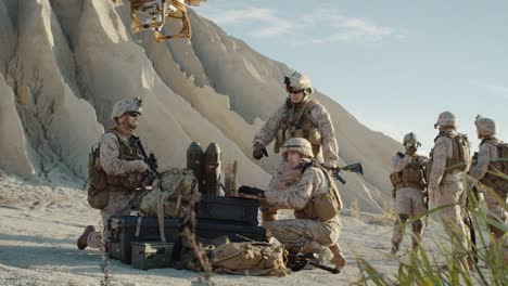 soldiers are using drone for scouting during military operation in the desert. slow motion.