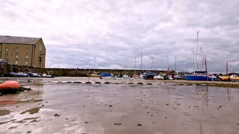 boats resting on sandy beach in fife, scotland