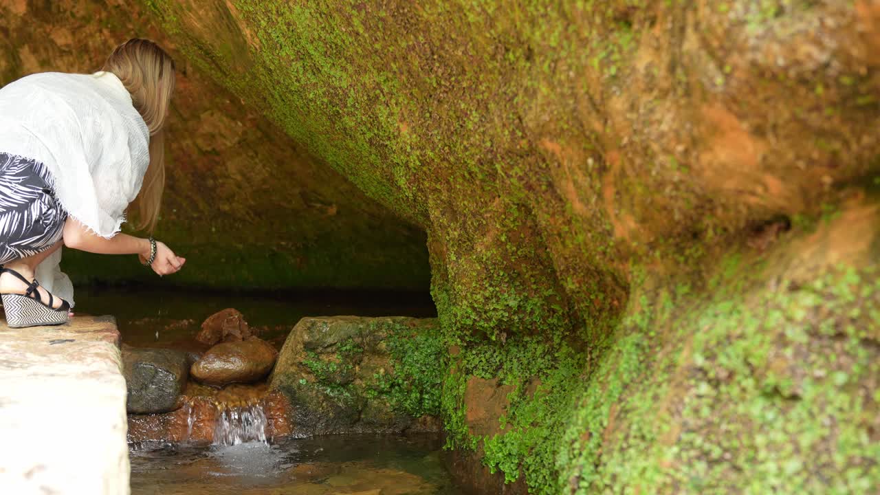 Unrecognizable Girl Water Sip: Woman Inside Gutman's Cave, Gauja National Park
