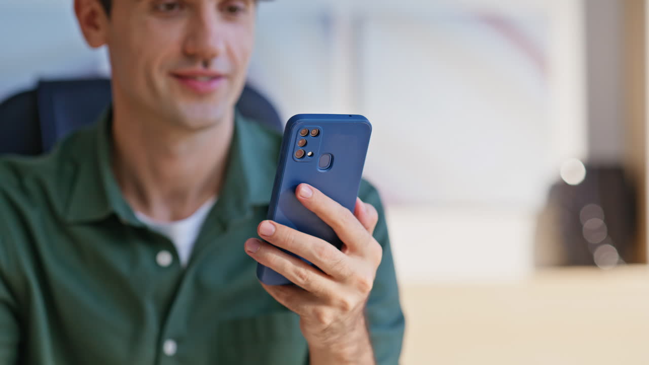 Startuper browsing mobile application at home workplace closeup. Man scrolling