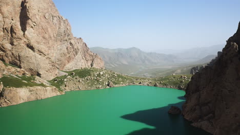 Slow-epic-cinematic-revealing-drone-shot-over-the-Kel-Suu-lake-and-its-ravine-in-Kyrgyzstan