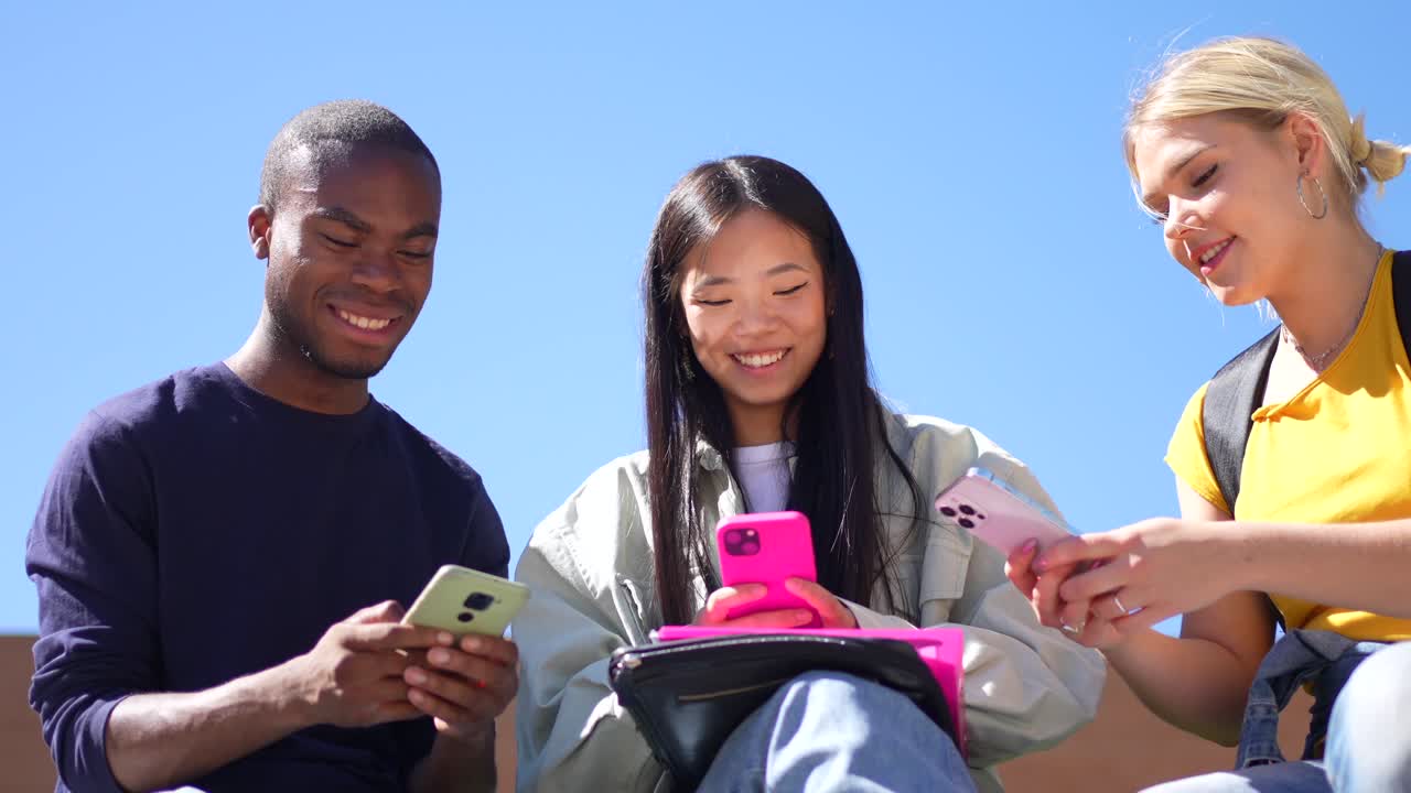 Friends Using Smartphones Outdoors