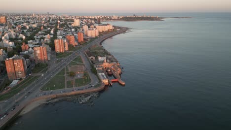 aerial-view-of-Montevideo-Uruguay-skyline-at-sunset-with-rambla-traffic-cars