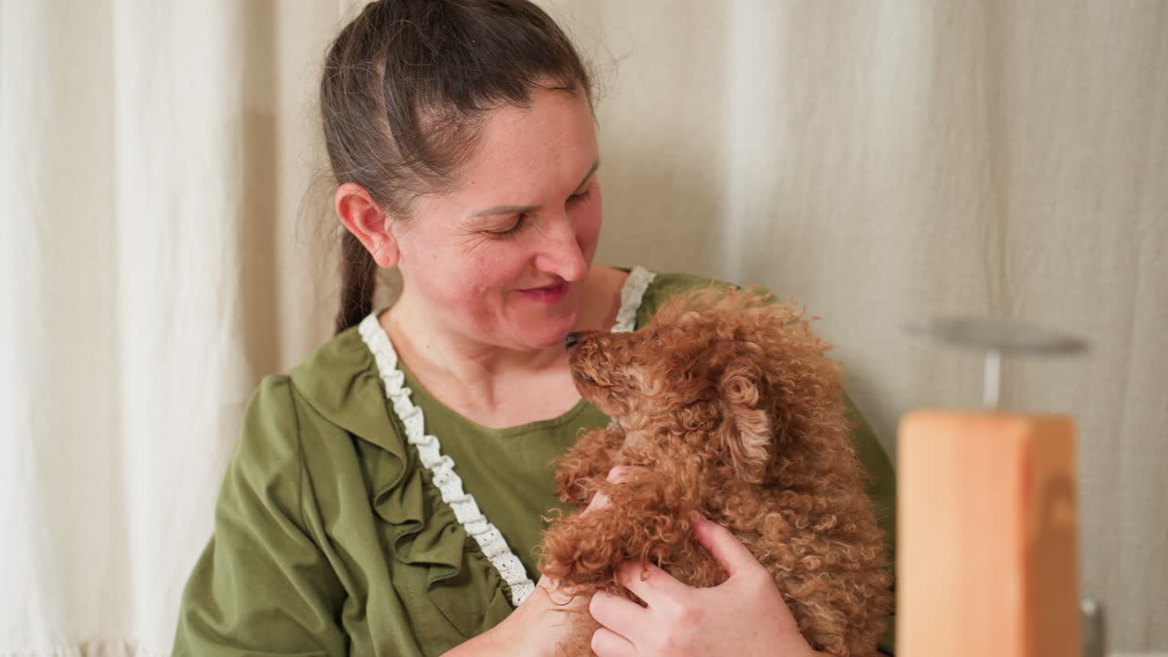 Housewife bonding closely with fluffy brown dog indoors, gently touching dog's neck and smiling warmly while resting forehead affectionately on pet, expressing deep emotional connection
