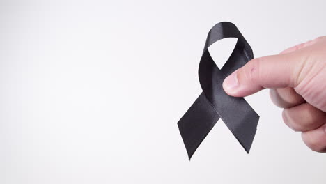 black awareness ribbon on gray background