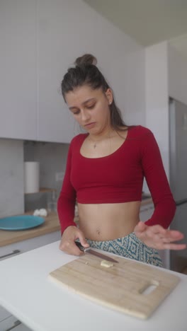 woman chopping garlic in a kitchen
