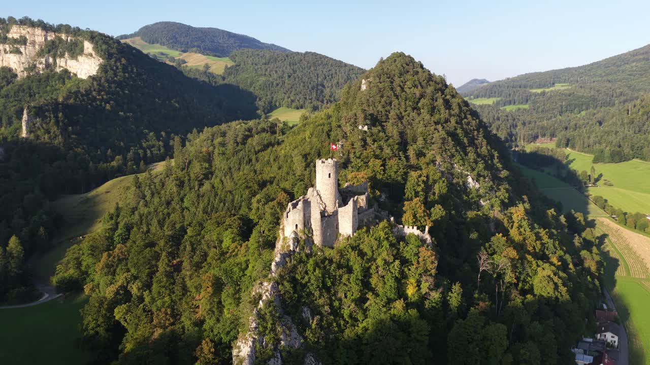 Ruin of Neu Falkenstein Castle, castle ruin in the swiss mountains. Aerial drone video