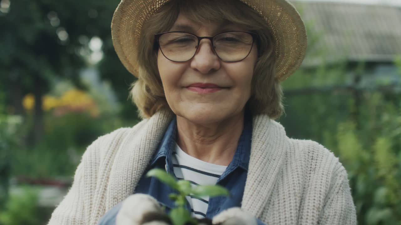 Senior Woman Planting a Seedling in Her Garden