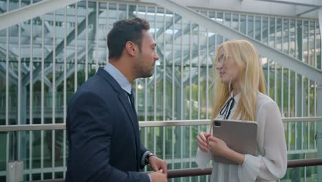 european business partners having happy conversation and giving high five outdoors. medium shot, slow motion