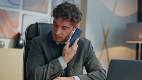 Busy specialist talking smartphone checking contract papers in office closeup