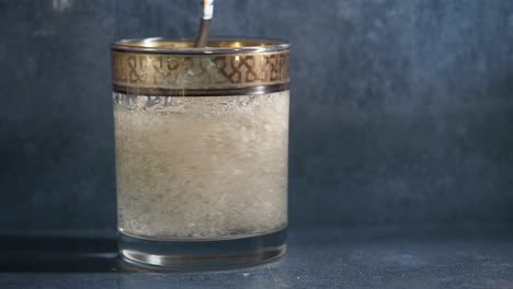 mixing a powdered drink in a glass