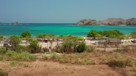 the white sand beach of tanjung aan in lombok, indonesia during a sunny day