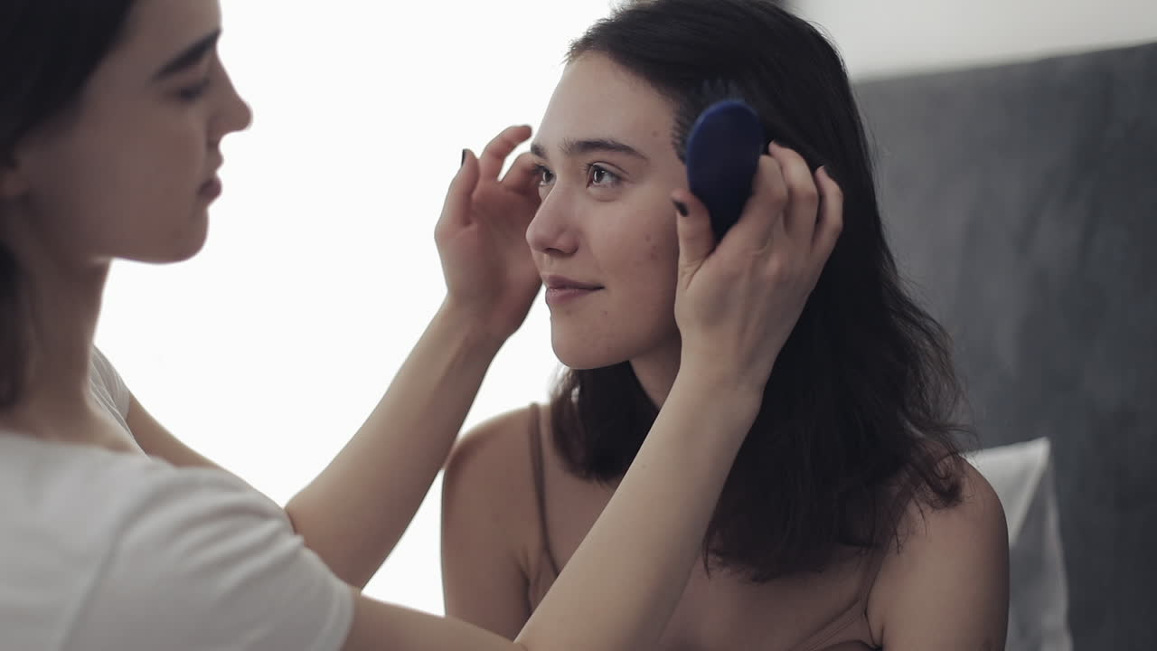 Two women with hair and hairbrush
