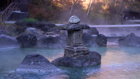 tight shot of stone pillar inside steaming onsen hot springs in japan