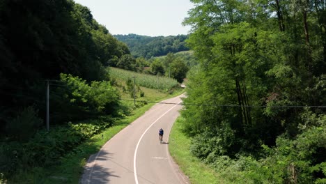 aerial view of cyclist on empty countryside road in serbia