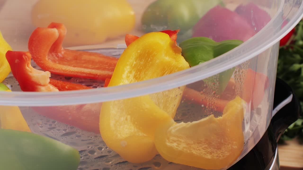 Mixed vegetables, carrots, broccoli, and cauliflower in a food double boiler steamer basket in a stainless steel pot, healthy diet cooking method preserving minerals, vitamins and flavor