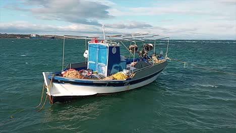 traditional carvel built greek fishing boat moored off lesbos island