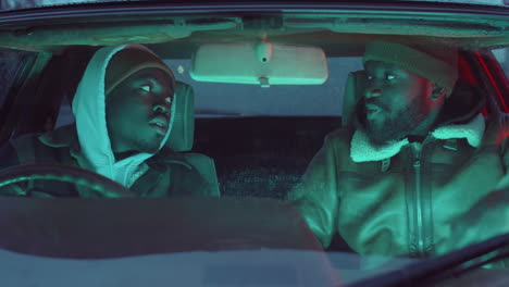 Two-Black-Men-Chatting-in-Car-in-Evening