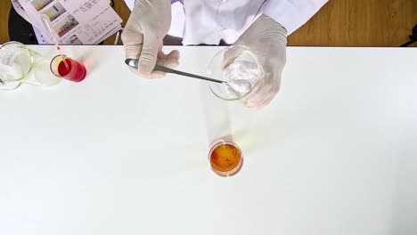 Scientist conducts a lava lamp experiment using food coloring and oil, showcasing vibrant color interactions in a laboratory setting