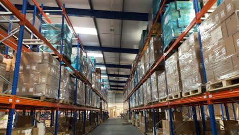 rising shot of a warehouse interior from behind a pallet truck