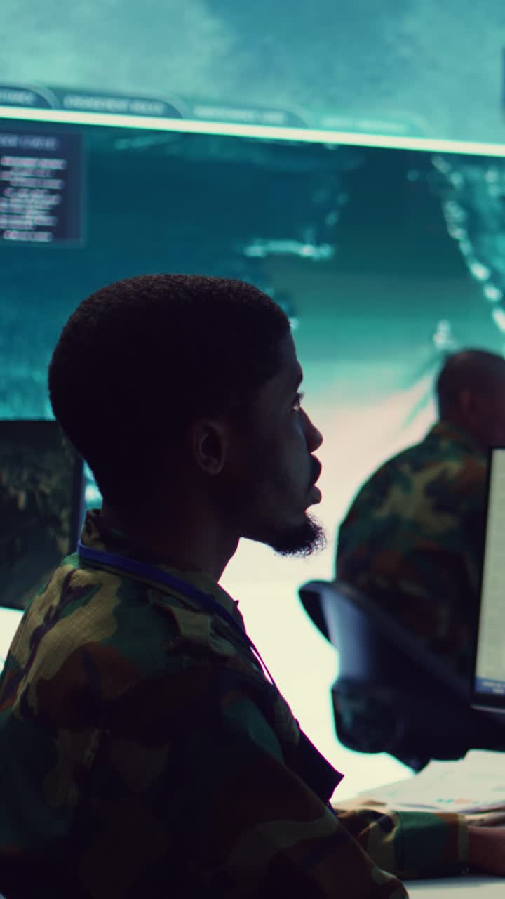 Military Analyst Monitoring Data in Control Room