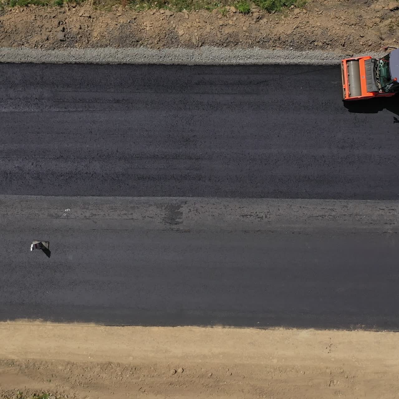 Road roller machine rolls asphalt