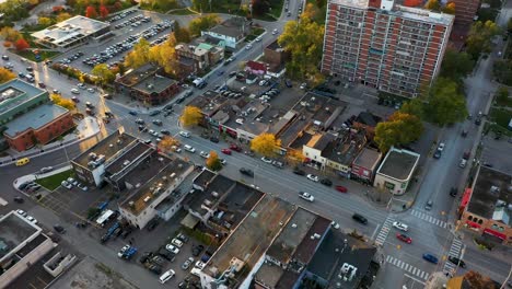 drone flying over downtown shops in mississauga at sunrise