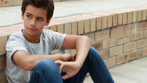 Sad-schoolboy-sitting-alone-on-staircase