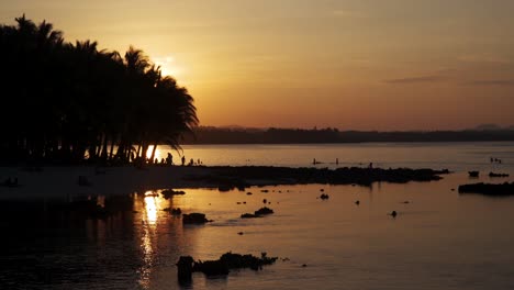 tide rolling out from a tropical beach at sunset