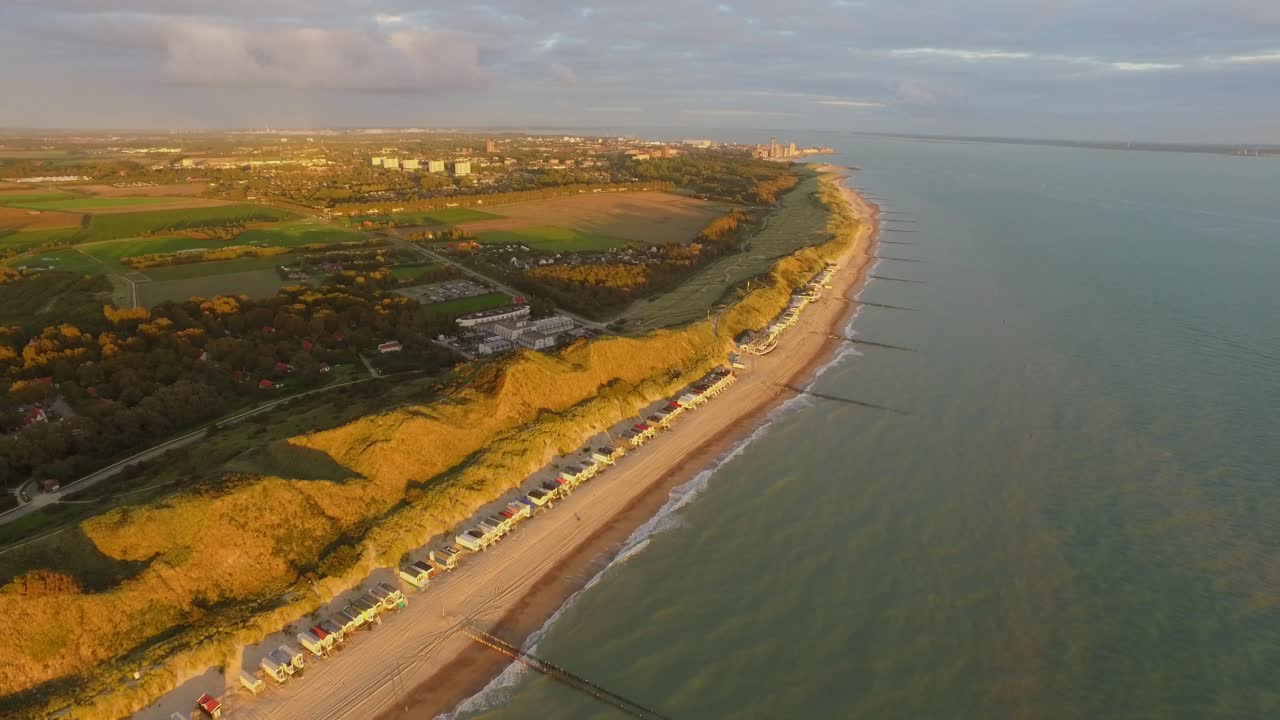 Aerial view of a beach with houses and buildings on the coast