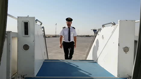 steward climbs steps of stairs to get on board of plane