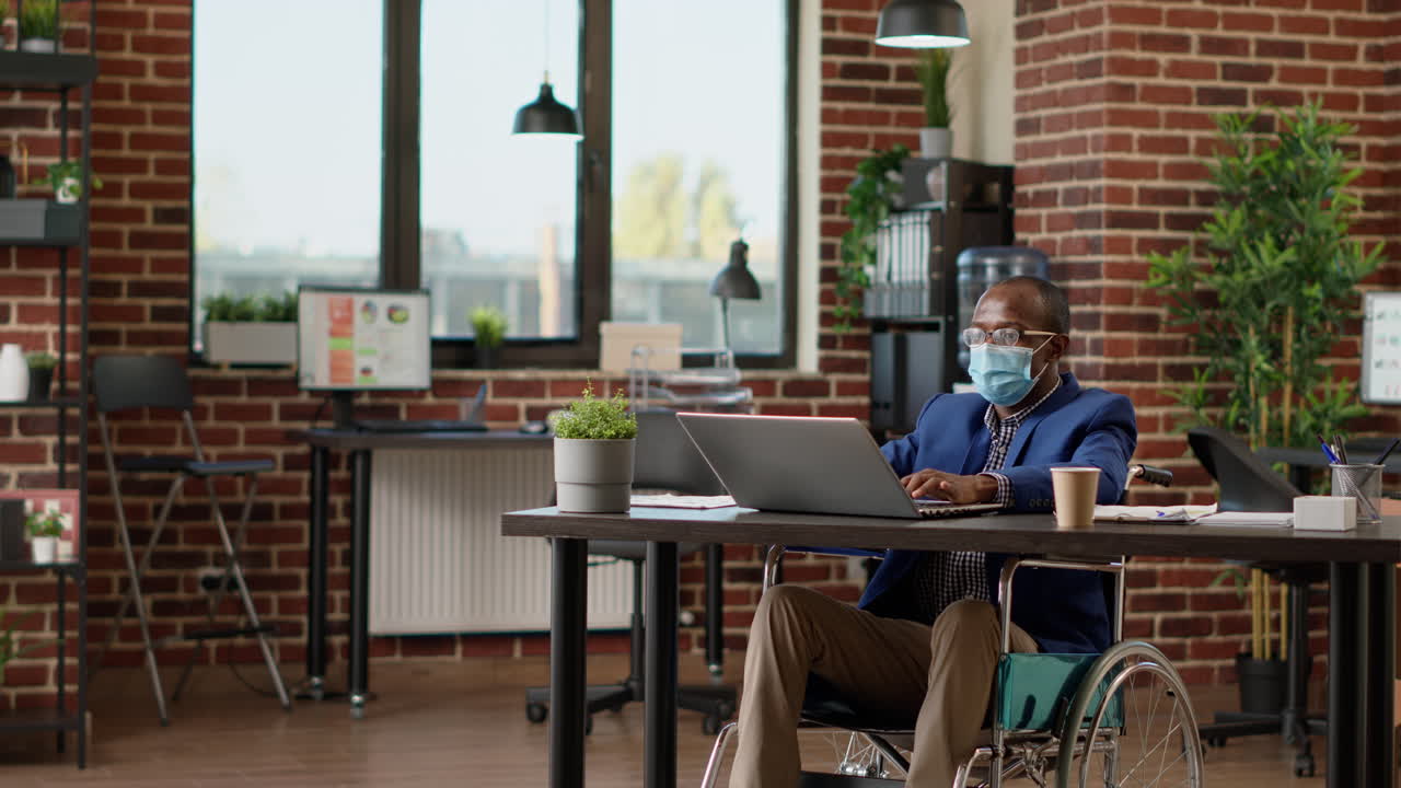 Sales consultant sitting in wheelchair and working on business