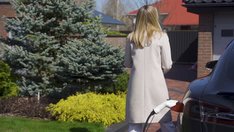 woman charging an electric car