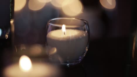 candles burning in tall glass candlestick, a restaurant, banquet, decoration, candles at the wedding table, decorative candles are lit on the festive table, close-up