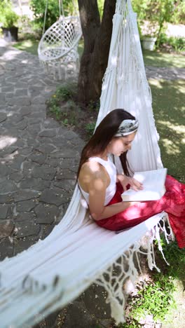 woman reading in a hammock in a garden