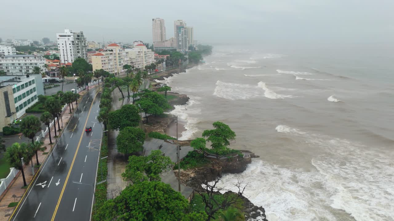 Rough sea and large waves crashing on coast during Tropical Storm Melissa, dangers of extreme weather, Santo Domingo, Dominican Republic. Aerial forward