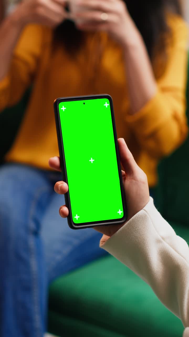 Video verticale: donna che controlla il display con green screen sullo smartphone